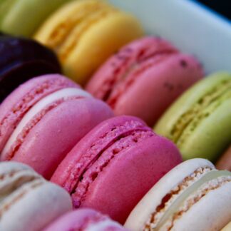 Multicolored macarons lined up in rows